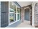 Inviting covered porch with stone accents, showcasing a window and elegant architectural details at 2011 Cedar Falls Dr # 71, Waxhaw, NC 28173