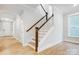 A naturally lit staircase with wood and white trim and wood floors at 2011 Cedar Falls Dr # 71, Waxhaw, NC 28173