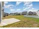 A beautiful, spacious backyard with a concrete patio, white picket fence and well-maintained lawn in a residential neighborhood at 2021 Boynton St, Charlotte, NC 28269