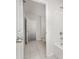 Bathroom with white tile flooring, white tub and shower and a doorway to another room at 2021 Boynton St, Charlotte, NC 28269