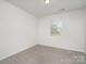 Bright bedroom with neutral carpet, one window, and a closet at 2021 Boynton St, Charlotte, NC 28269