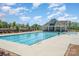 A well-maintained community pool with clear blue water, surrounded by lounge chairs and lush landscaping at 2021 Boynton St, Charlotte, NC 28269