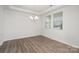 Bright dining room with modern chandelier and natural light streaming through the windows at 2021 Boynton St, Charlotte, NC 28269