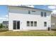 Back exterior showcasing a two-story home with white siding, sliding glass door and a small concrete patio at 2021 Boynton St, Charlotte, NC 28269