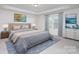 Luxurious main bedroom with a tufted headboard, soft lighting, and elegant decor for restful nights at 2021 Boynton St, Charlotte, NC 28269