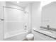 Bathroom featuring a shower-tub combo with a white shower surround, granite countertop, and modern fixtures at 220 S Columbia St, Gastonia, NC 28054