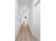 Hallway with wood-look flooring and multiple white doors at 220 S Columbia St, Gastonia, NC 28054