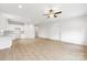 Spacious, open-concept area features modern light fixture, ceiling fan, wood-look flooring, and an eat-in kitchen at 220 S Columbia St, Gastonia, NC 28054