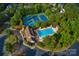 Aerial view of community amenities including pool, clubhouse, tennis and pickleball courts surrounded by trees at 2215 Maycroft Dr, Charlotte, NC 28262