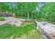 Aerial view of a backyard featuring a pool, a hot tub, a fire pit, a seating area, and lush landscaping at 2215 Maycroft Dr, Charlotte, NC 28262