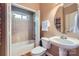 Cozy bathroom featuring a shower-tub combo, toilet, and pedestal sink with a large mirror at 2215 Maycroft Dr, Charlotte, NC 28262
