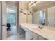 Bright bathroom features a white sink vanity and a doorway leading into the bedroom at 2215 Maycroft Dr, Charlotte, NC 28262