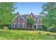 Traditional brick home featuring blue shutters and manicured landscaping at 2215 Maycroft Dr, Charlotte, NC 28262
