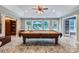 Entertain in the finished basement featuring a full pool table and access to an outdoor patio and pool at 2215 Maycroft Dr, Charlotte, NC 28262