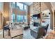 Bright living room with a stone fireplace, built-in shelving, and large windows at 2215 Maycroft Dr, Charlotte, NC 28262