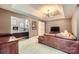 Relax in style in this cozy living room with a wet bar and comfortable seating at 2215 Maycroft Dr, Charlotte, NC 28262