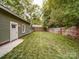 Green backyard featuring a detached garage and a well-maintained lawn with a wooden fence at 226 Union S St, Concord, NC 28025