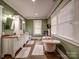 Elegant bathroom with a soaking tub, double vanity, and stylish fixtures at 226 Union S St, Concord, NC 28025