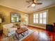 Sunlit bedroom featuring hardwood floors, plantation shutters, and neutral decor at 226 Union S St, Concord, NC 28025