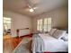 Bright bedroom with hardwood floors, a walk-in closet, shuttered windows, and a comfy bed at 226 Union S St, Concord, NC 28025