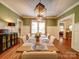 Spacious dining room with large windows, hardwood floors, and seating for ten at 226 Union S St, Concord, NC 28025