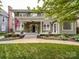 Charming green house with a welcoming front porch and a neatly manicured lawn at 226 Union S St, Concord, NC 28025