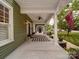 Charming front porch with a ceiling fan, potted plants, and a welcoming entrance at 226 Union S St, Concord, NC 28025