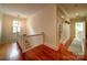 Upper level hallway with hardwood floors, white walls, and access to multiple rooms at 226 Union S St, Concord, NC 28025