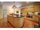 Bright kitchen features wood cabinets, a dark granite island, stainless steel appliances, and a unique light fixture at 226 Union S St, Concord, NC 28025