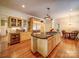 Well-lit kitchen showcasing custom cabinetry, a black granite island with cooktop, and stainless steel appliances at 226 Union S St, Concord, NC 28025