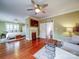 Open living room with fireplace, hardwood floors, and view to the bedroom at 226 Union S St, Concord, NC 28025