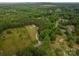 An aerial view shows the property with a long private driveway surrounded by mature trees at 2609 Cove Creek Dr, Gastonia, NC 28056
