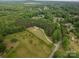 An aerial view of the home and property showcasing the lush landscaping and wooded acreage at 2609 Cove Creek Dr, Gastonia, NC 28056