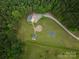 Overhead aerial view shows home's location, gravel drive, and outdoor spaces at 2609 Cove Creek Dr, Gastonia, NC 28056
