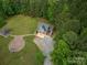 An aerial view showing a home with a two-car garage, patio, gazebo and abundant greenery at 2609 Cove Creek Dr, Gastonia, NC 28056