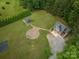 Aerial shot featuring the house, patio with fire pit, gazebo, and extensive lawn at 2609 Cove Creek Dr, Gastonia, NC 28056