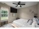 Comfortable bedroom featuring a ceiling fan, closet, and natural light from the window at 2609 Cove Creek Dr, Gastonia, NC 28056