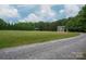 Peaceful home with a two-car garage, a gazebo, and a stone driveway, set amidst lush greenery at 2609 Cove Creek Dr, Gastonia, NC 28056