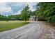 Charming home featuring a two-car garage and a wooden deck overlooking lush greenery at 2609 Cove Creek Dr, Gastonia, NC 28056