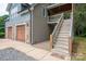 Charming home featuring a two-car garage and a welcoming elevated entrance with wooden stairs at 2609 Cove Creek Dr, Gastonia, NC 28056