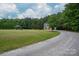 Secluded home featuring a two-car garage, a gazebo, and a long, private driveway amidst lush greenery at 2609 Cove Creek Dr, Gastonia, NC 28056