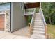 Exterior side view of the house with wooden stairs leading to an elevated entrance at 2609 Cove Creek Dr, Gastonia, NC 28056