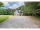 A detached two-car garage with private stairway and ample gravel parking at 2609 Cove Creek Dr, Gastonia, NC 28056