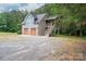 A close exterior of the two-car detached garage featuring private staircase and stone accents at 2609 Cove Creek Dr, Gastonia, NC 28056