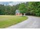 Detached two-car garage with private stairway and a view of the surrounding wooded area at 2609 Cove Creek Dr, Gastonia, NC 28056