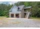 Two-car garage with upstairs apartment, surrounded by mature trees at 2609 Cove Creek Dr, Gastonia, NC 28056