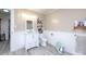Neutral bathroom with white wainscoting, gray floors, storage shelves, and modern vanity at 303 Island Ford Rd, Maiden, NC 28650