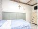 Bedroom with an accent wall, cross decor, white dresser, and gray wood-look flooring at 303 Island Ford Rd, Maiden, NC 28650