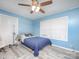 Blue bedroom with natural light, a ceiling fan, and light-colored vinyl flooring at 303 Island Ford Rd, Maiden, NC 28650