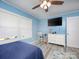 Blue bedroom with a ceiling fan, natural light, and light-colored vinyl flooring at 303 Island Ford Rd, Maiden, NC 28650